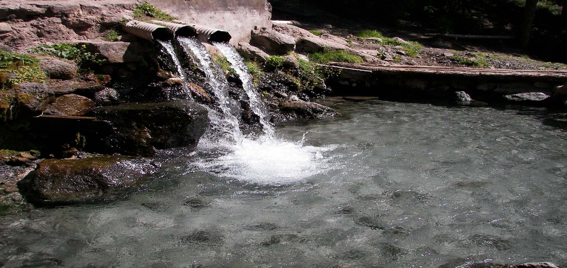 A serene waterfall cascades down rocky terrain
